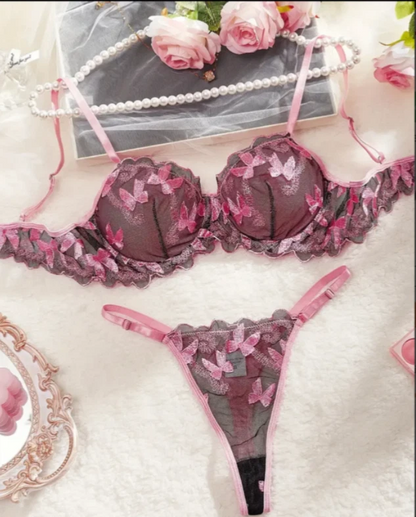 Lace lingerie set with pink accents on a decorative background
