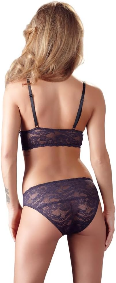 Woman wearing a dark lace lingerie set on a white background