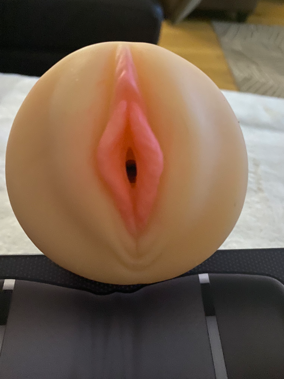 Silicone mold shaped like a female reproductive器官 on a black surface.