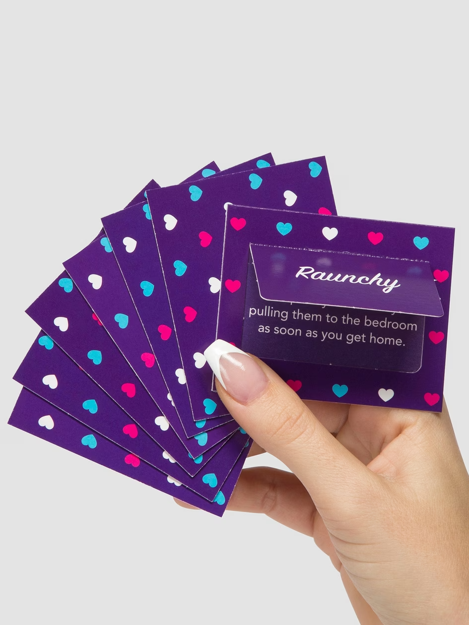 Hand holding a deck of purple cards with heart patterns and text on a light gray background