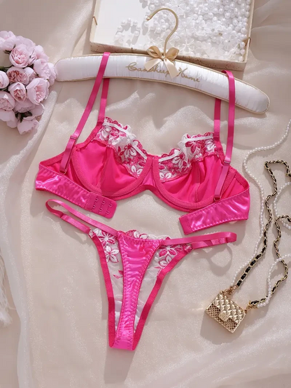 Pink lingerie set with floral details on a light background