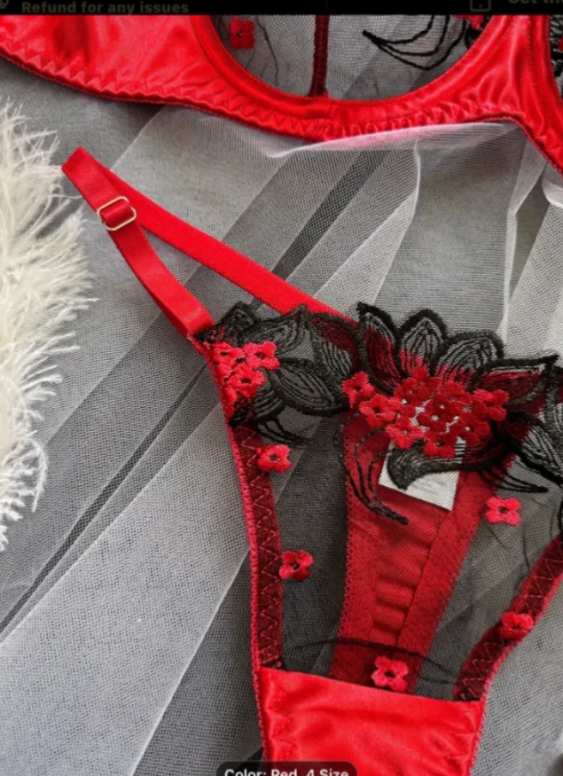 Red and black lingerie set on a gray background