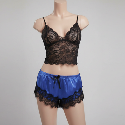 Black lace bra and blue satin shorts on a mannequin against a gray background