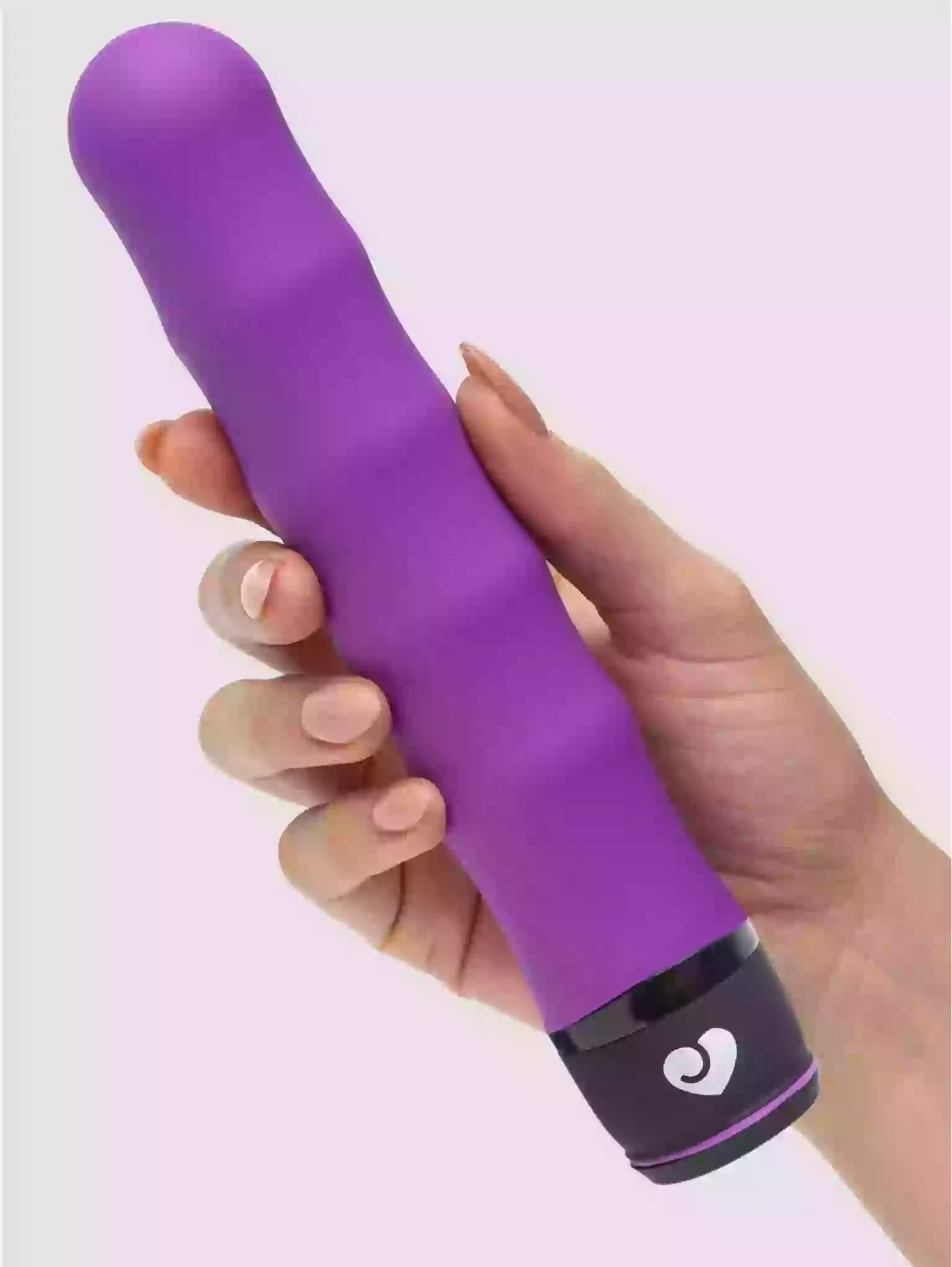 Purple electronic device held in a hand against a light purple background