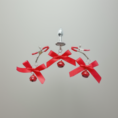 Earrings with red bows and small bells on a white background