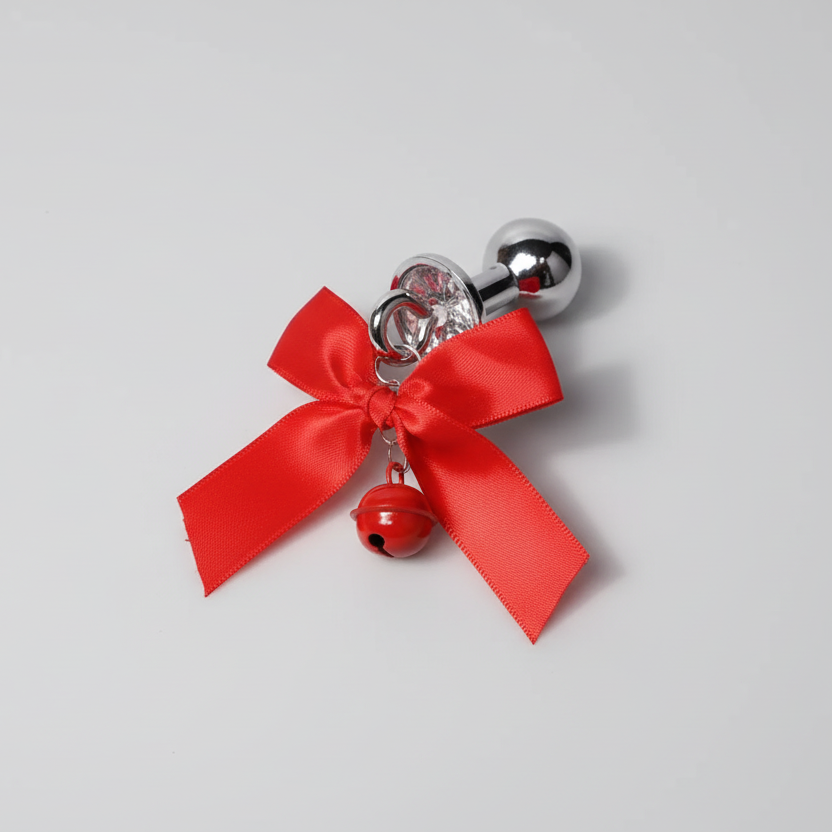 Decorative item with a red bow and bell on a gray background