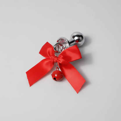 Decorative item with a red bow and bell on a gray background