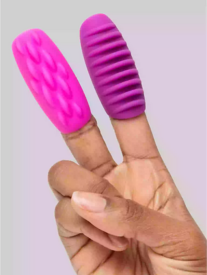 Pink and purple finger exercisers on a person's fingers against a light background