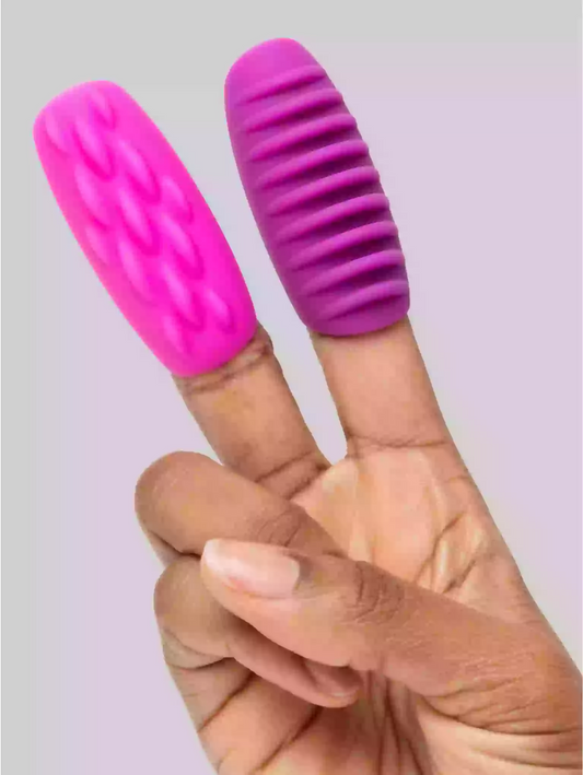 Pink and purple finger exercisers on a person's fingers against a light background