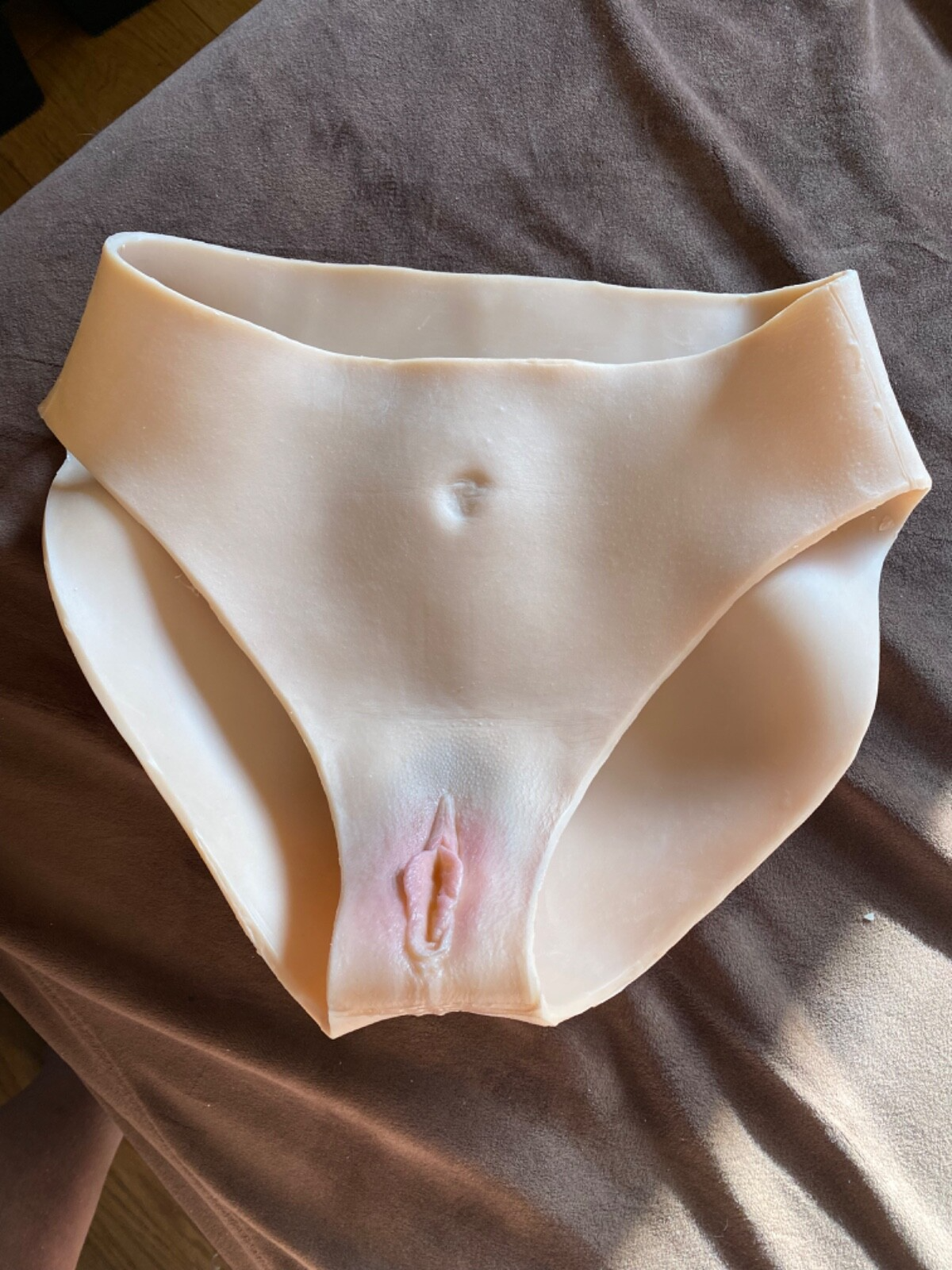 Beige underwear on a brown surface