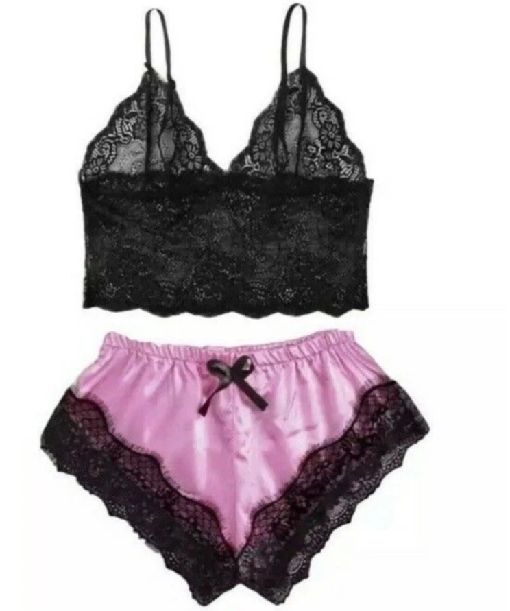 Black lace bra and pink satin shorts on a white background