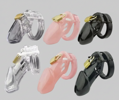 Set of three hearing aids in clear, pink, and black on a gray background
