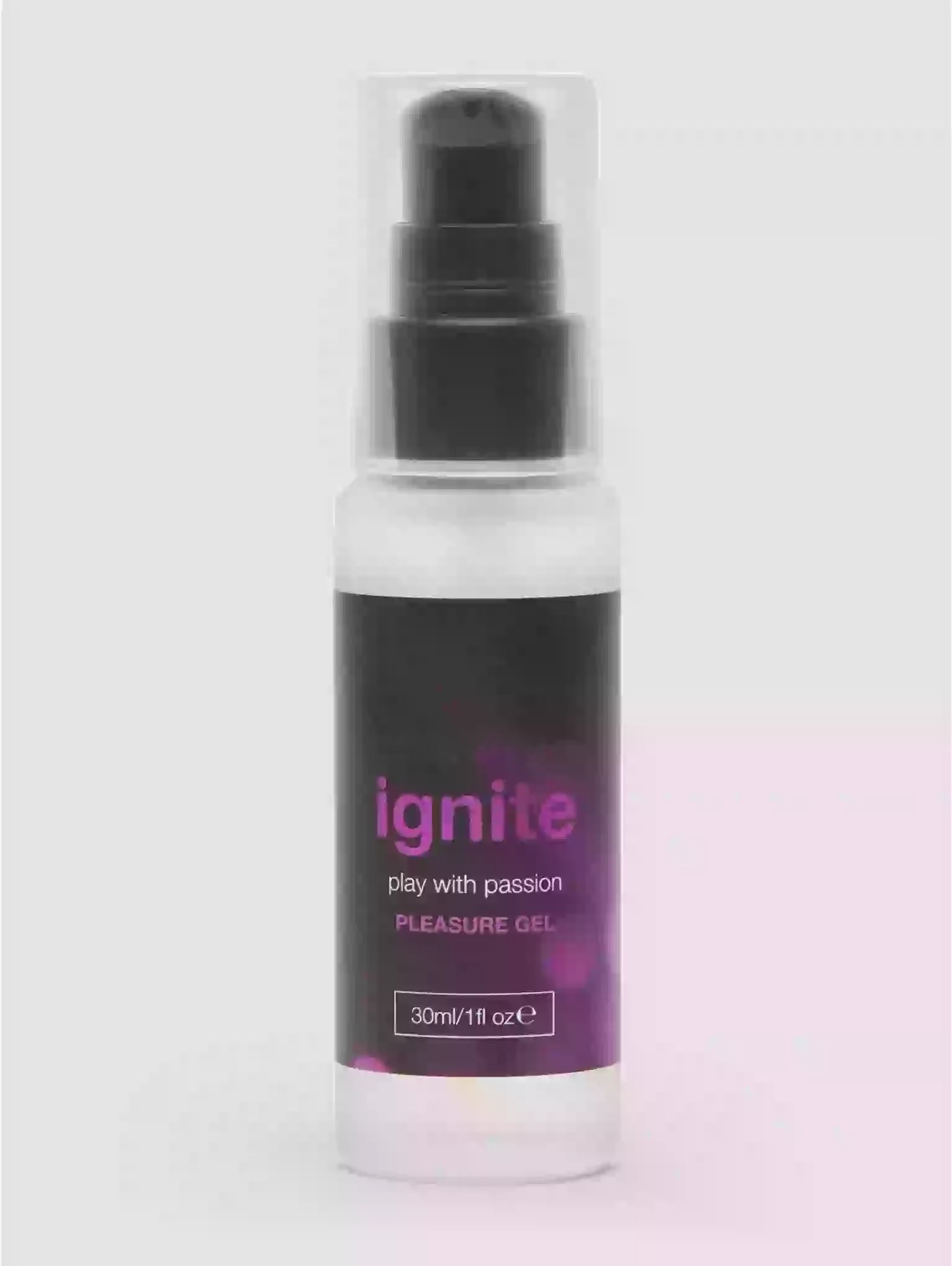 Bottle of 'ignite' pleasure gel with a spray nozzle on a light gray background
