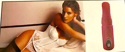 Woman lying on a bed with a pink and red massager next to her.