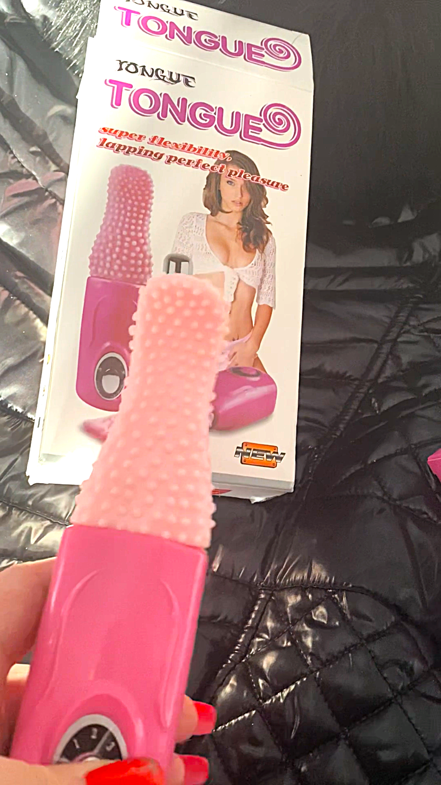 Pink tongue depressor with packaging on a dark textured surface