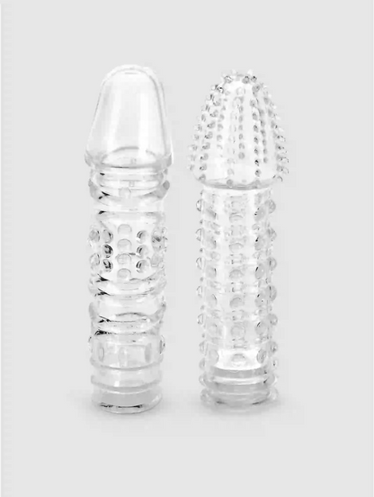 Two clear glass bottles with textured designs on a light gray background