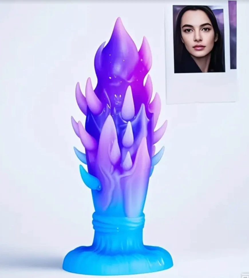 Colorful, flame-like object with a portrait of a woman in the corner on a light gray background