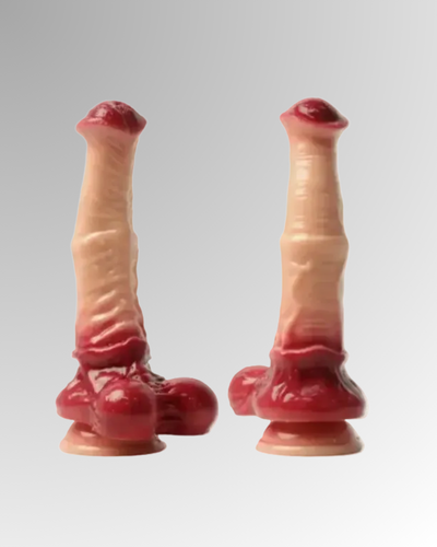 Two artificial penises with red tips on a gray background