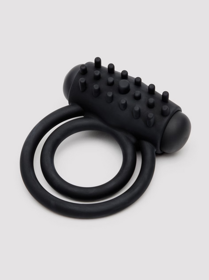 Black silicone ring with textured design on a light gray background