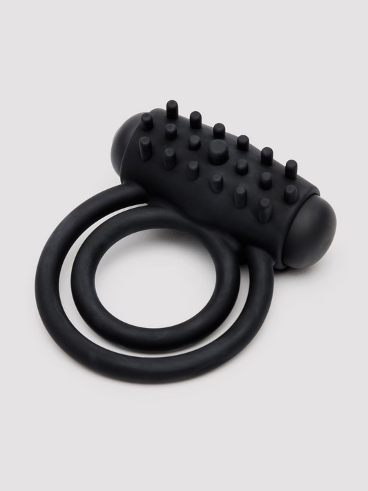 Black silicone ring with textured design on a light gray background