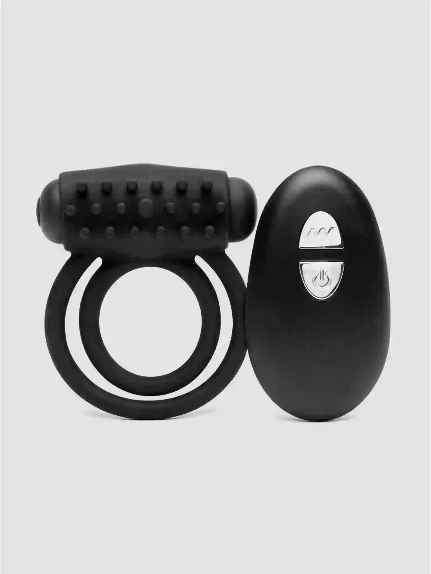 Black ring and remote control device on a light gray background