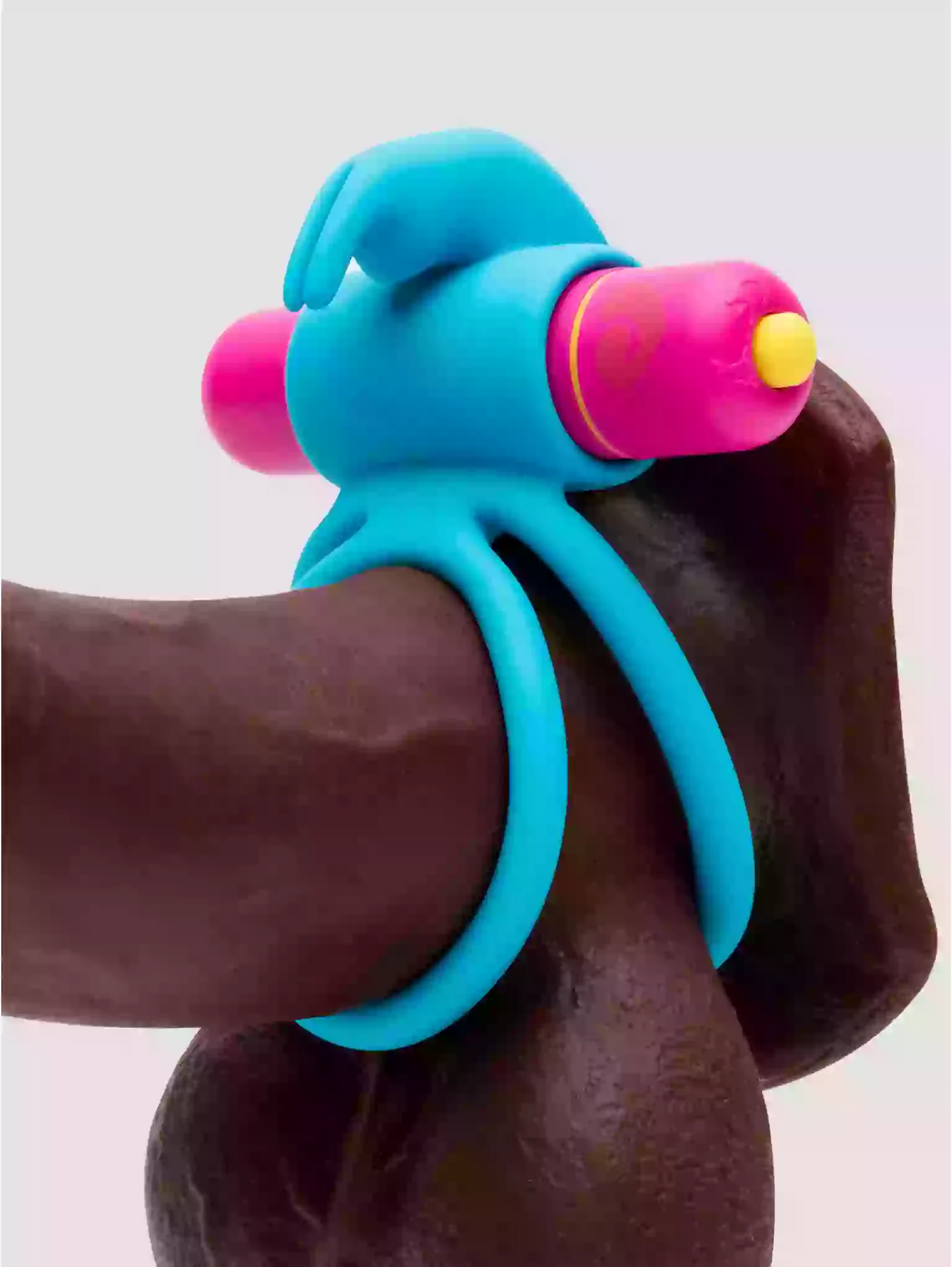 Blue and pink plastic tool on a person's arm against a light background
