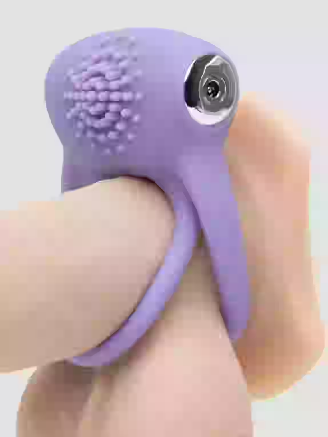 Purple silicone ring with textured surface and metallic component on a light background