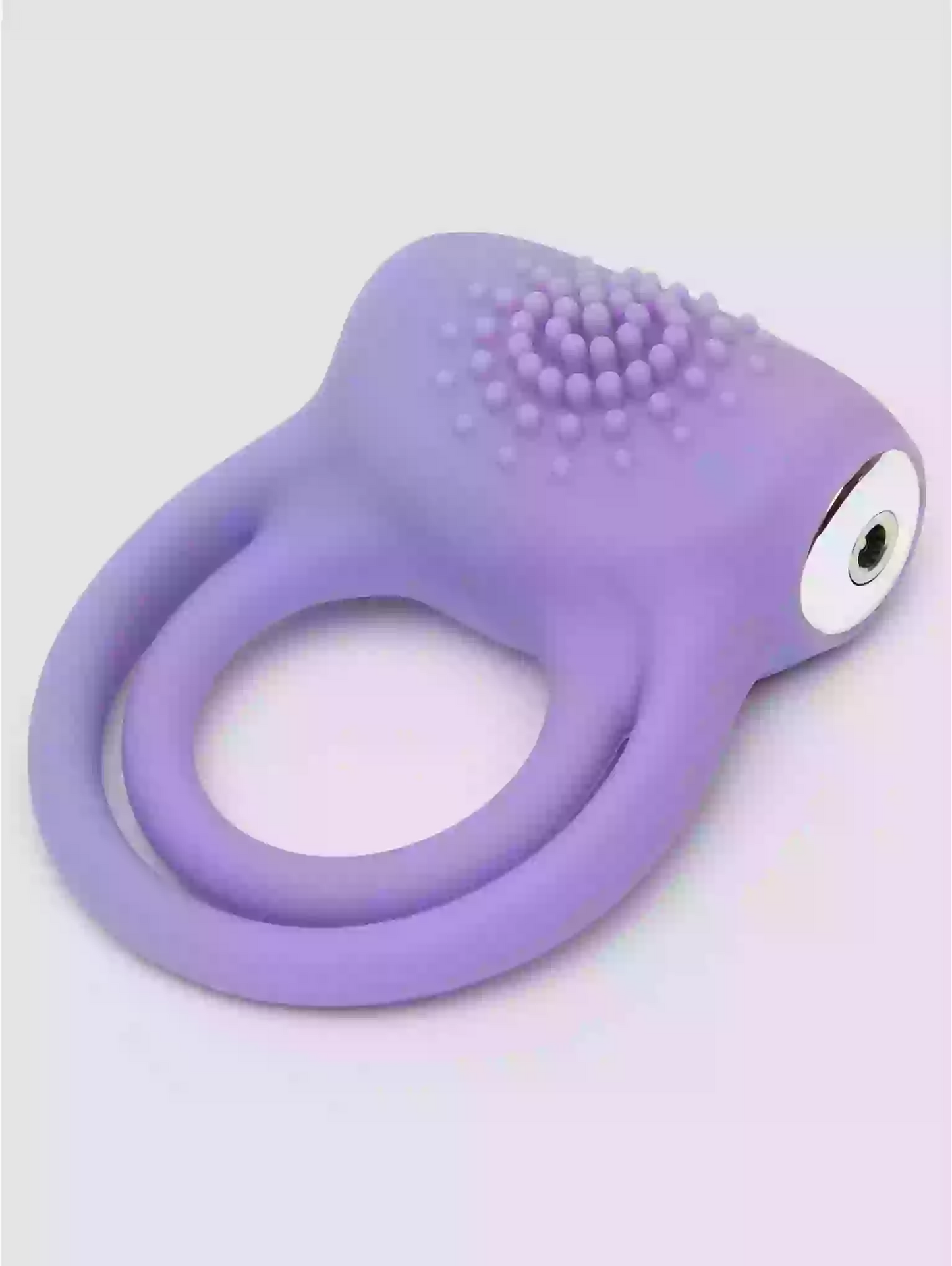Purple silicone ring with textured design on a light gray background