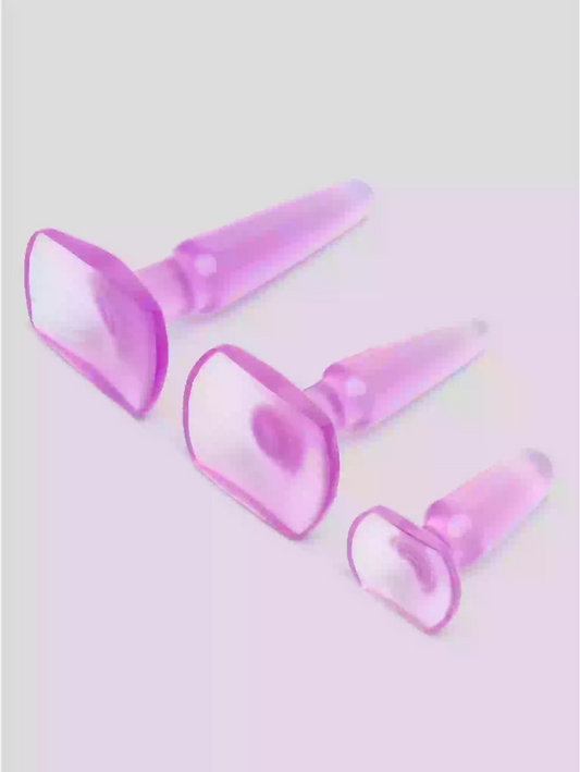 Set of four pink silicone cone-shaped objects on a light gray background
