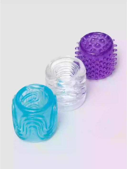 Three textured silicone cups in blue, clear, and purple on a light gray background