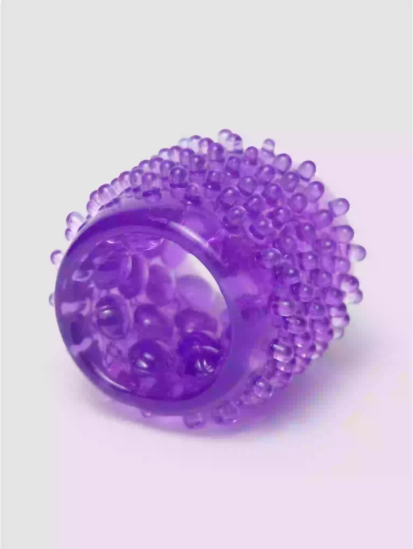 Purple textured ball on a light purple background