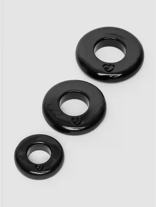 Three black rubber washers on a white background