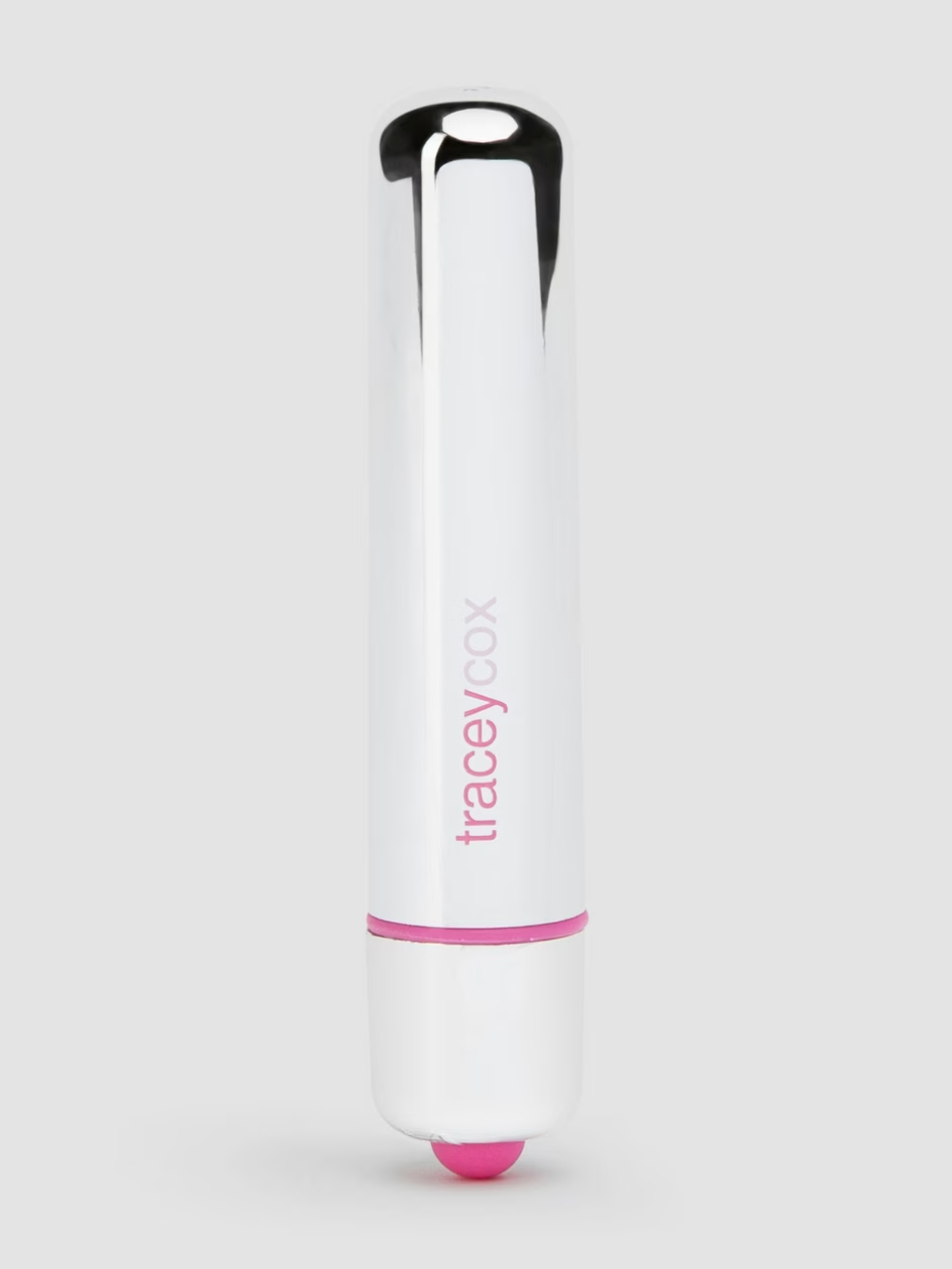 White and pink lip balm with 'tracey zoe' branding on a light gray background