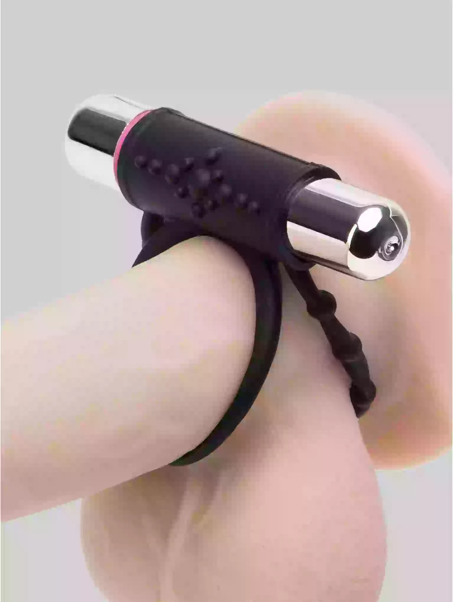 Black and silver device on a person's leg with a gray background