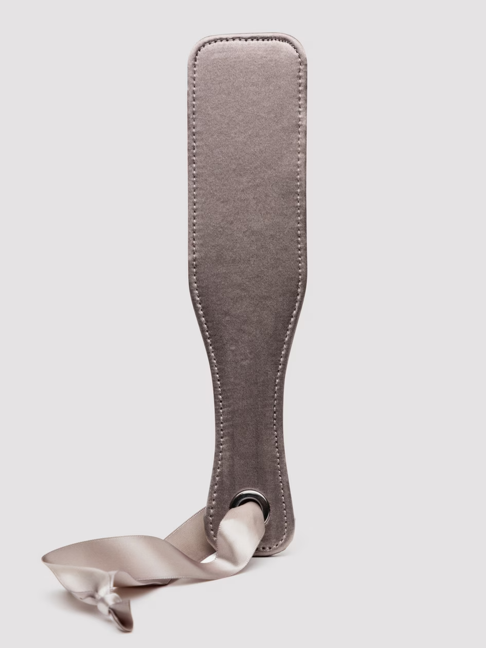 Gray leather strop with a white rope on a light gray background