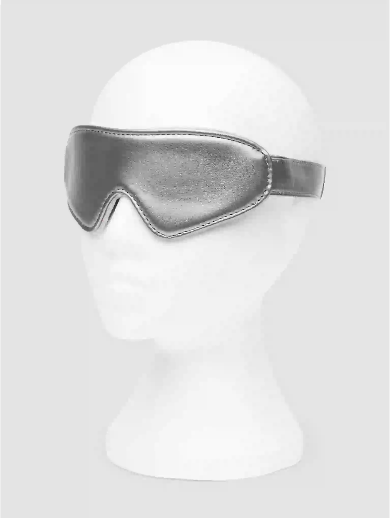 Silver sleep mask on a white mannequin head against a white background