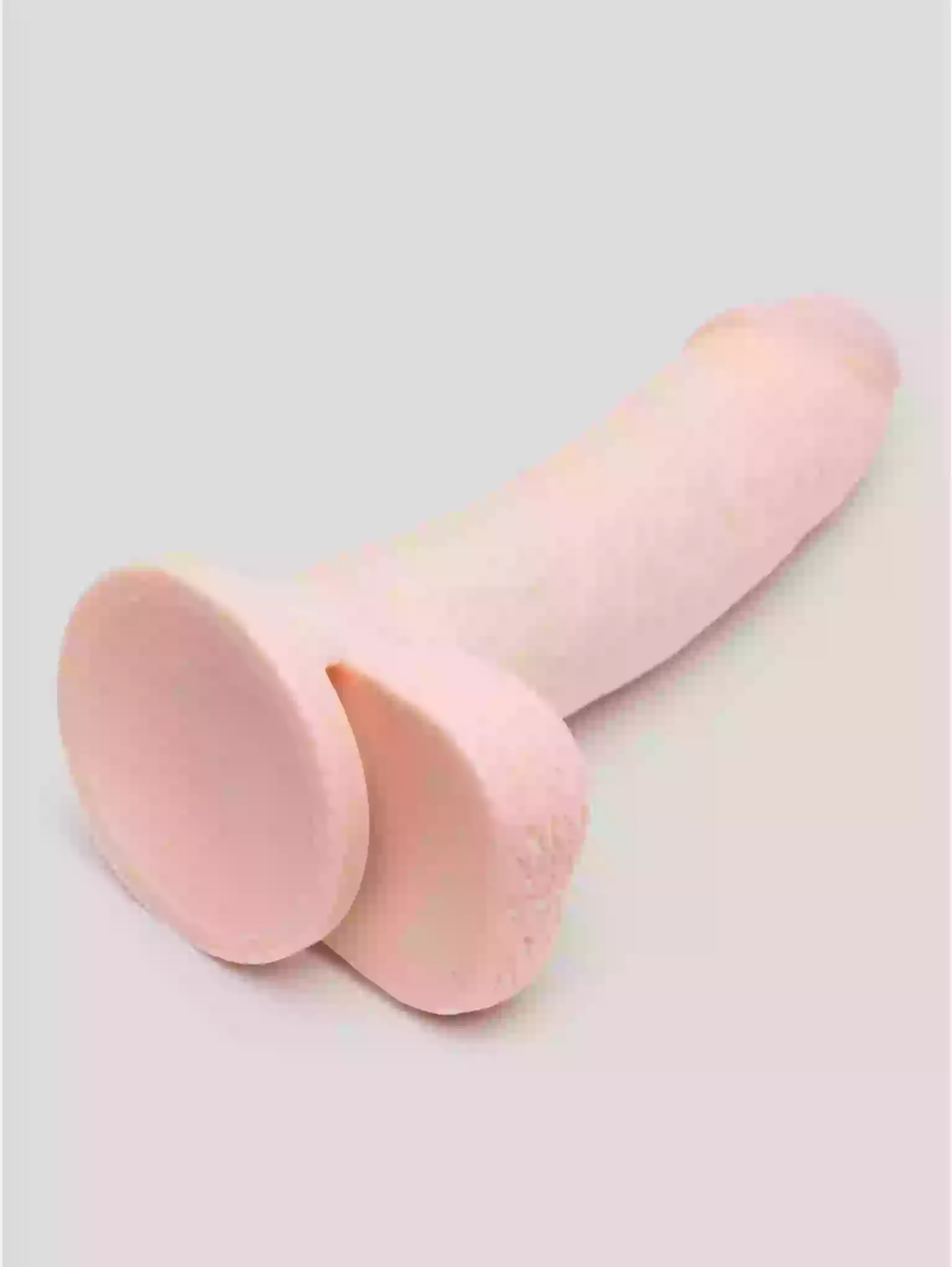 Two pink silicone cups on a light gray background
