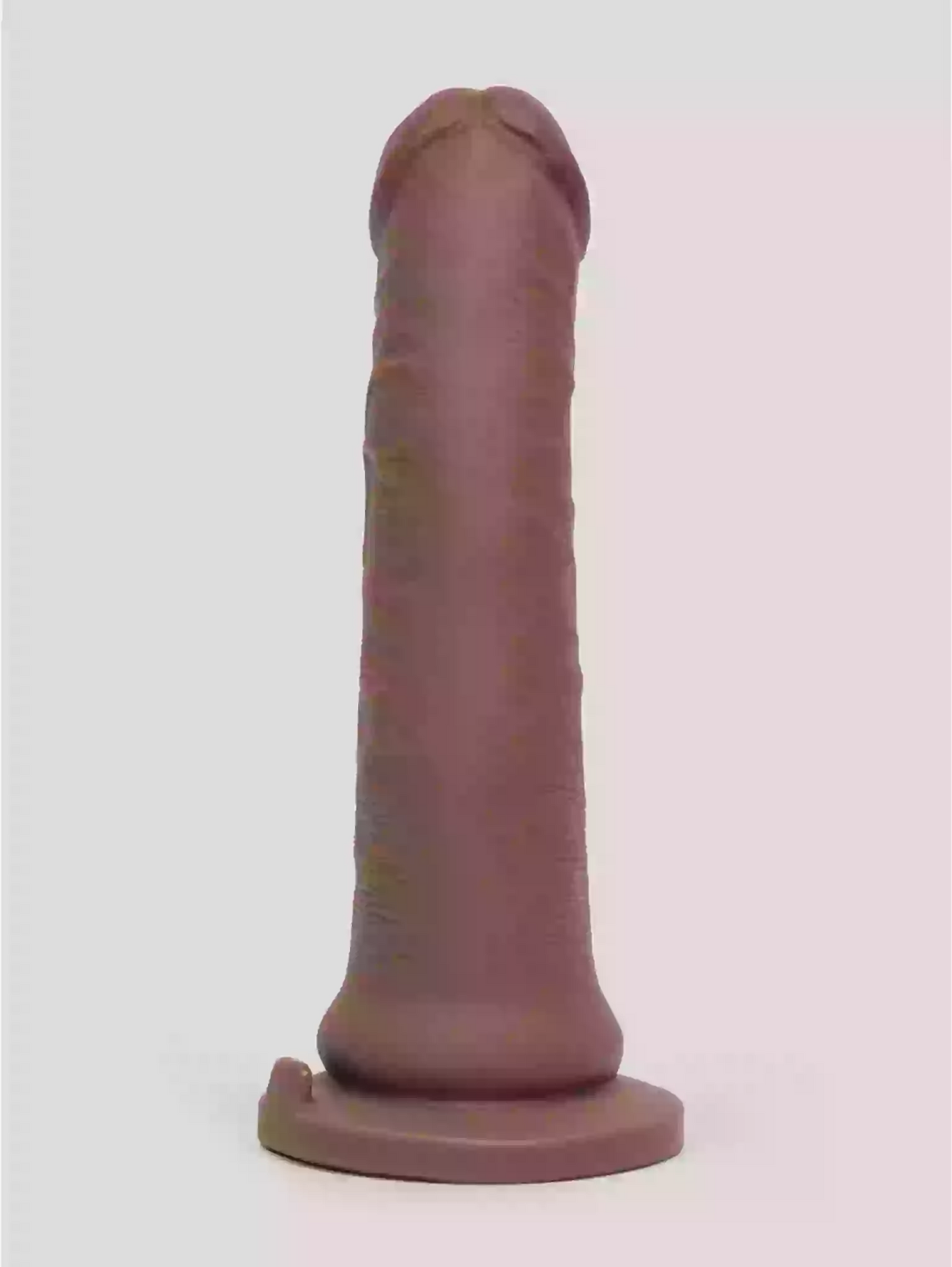 Plastic model of a phallic shape on a white background