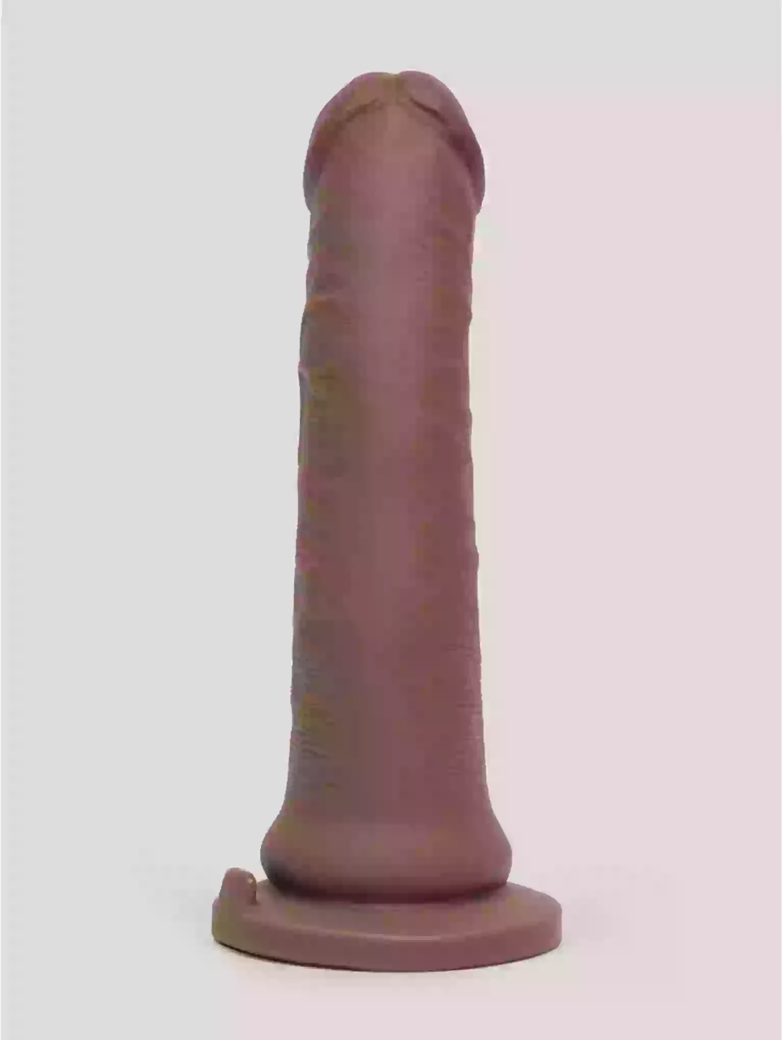 Plastic model of a phallic shape on a white background