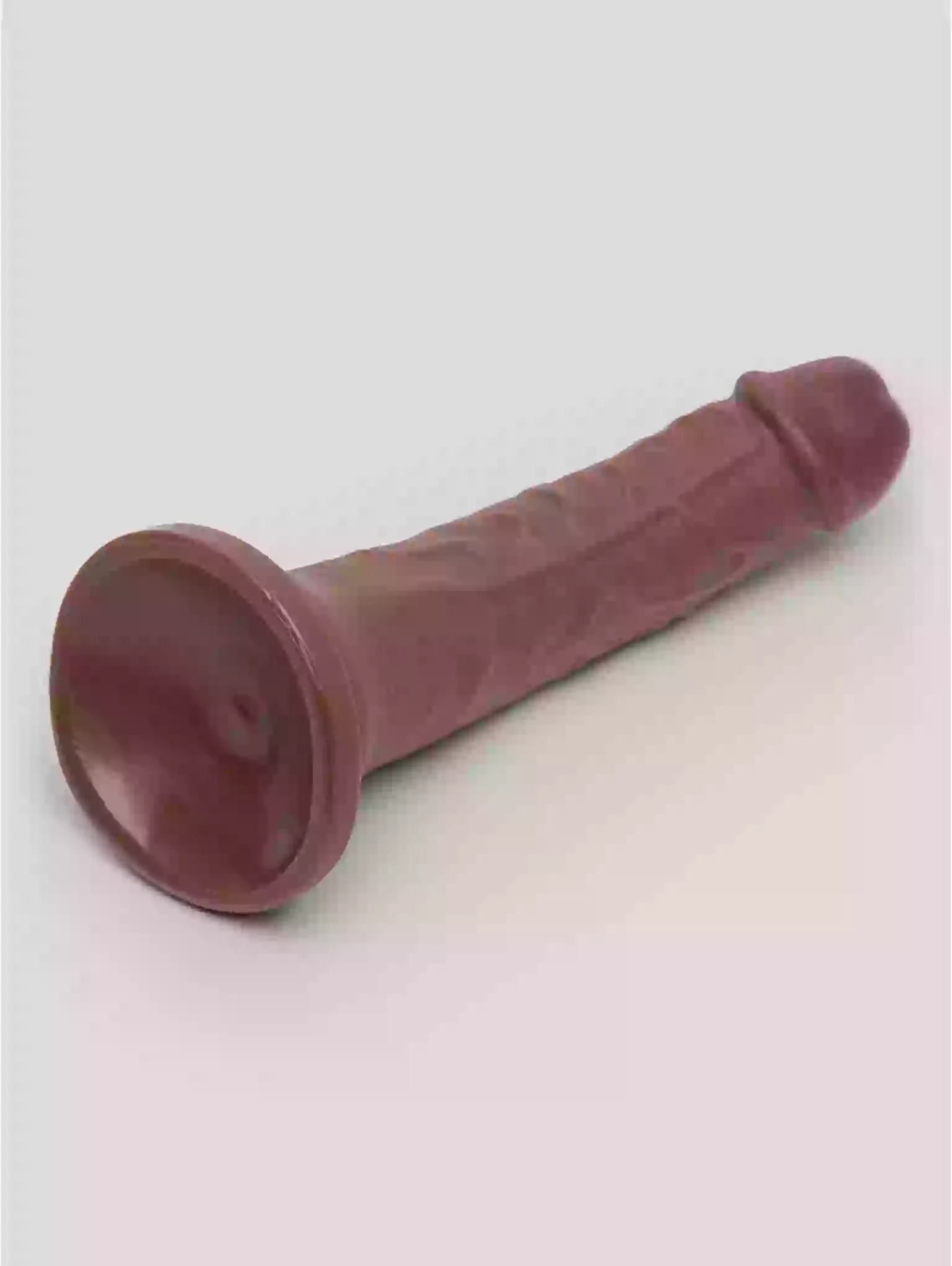 Red rubber cone-shaped object on a light gray background