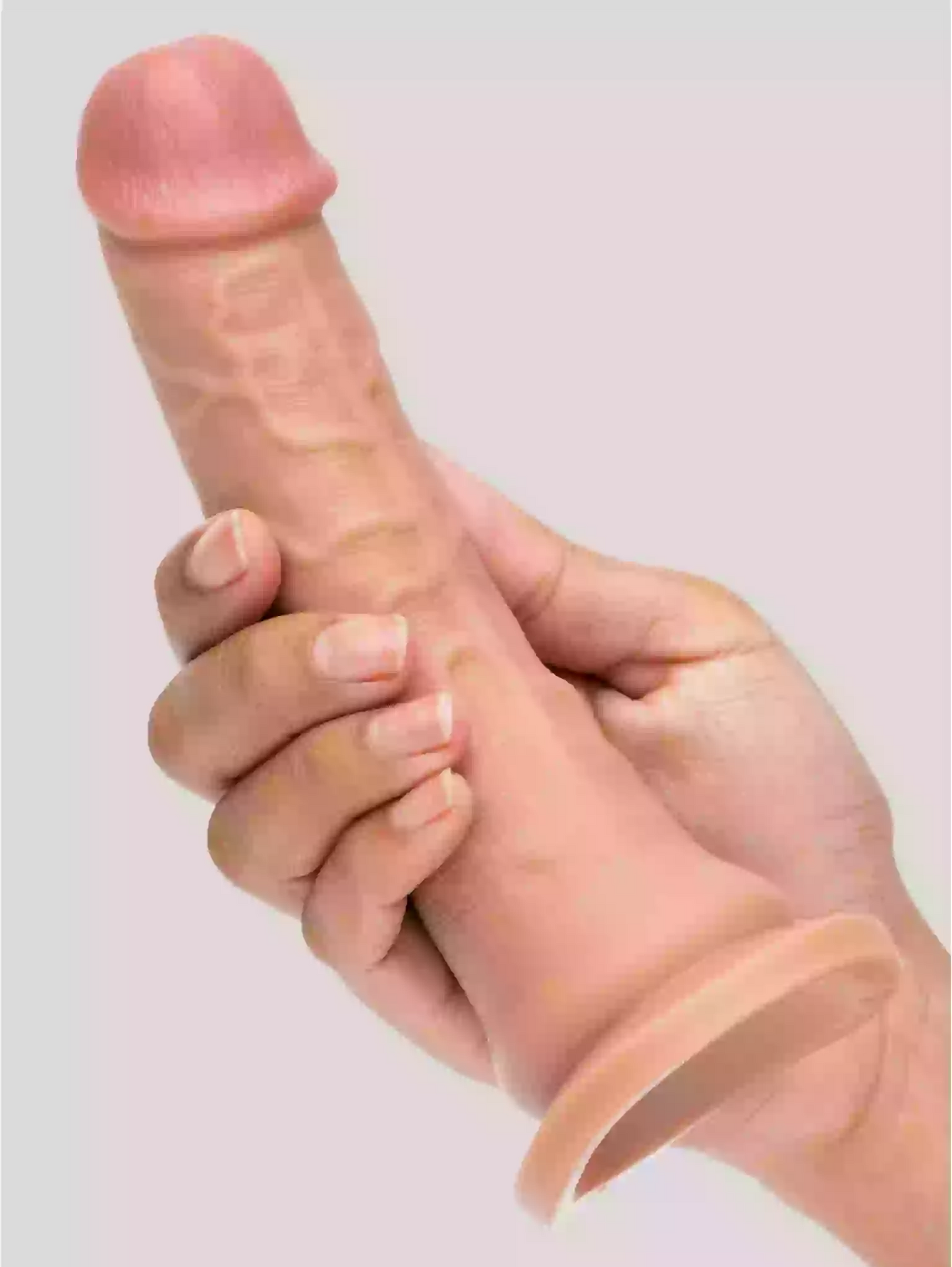 Hand holding a silicone sleeve with a cylindrical object inside on a plain background
