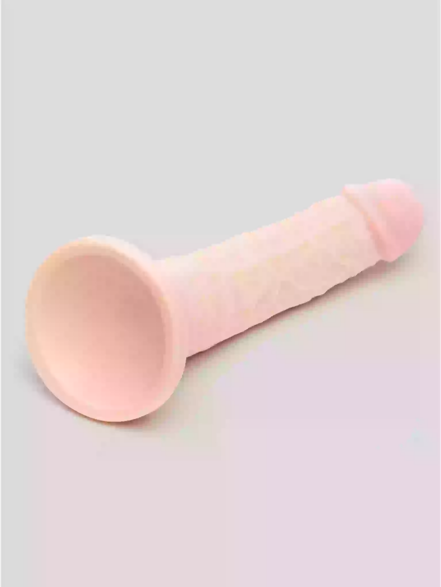 Pink makeup brush on a light gray background