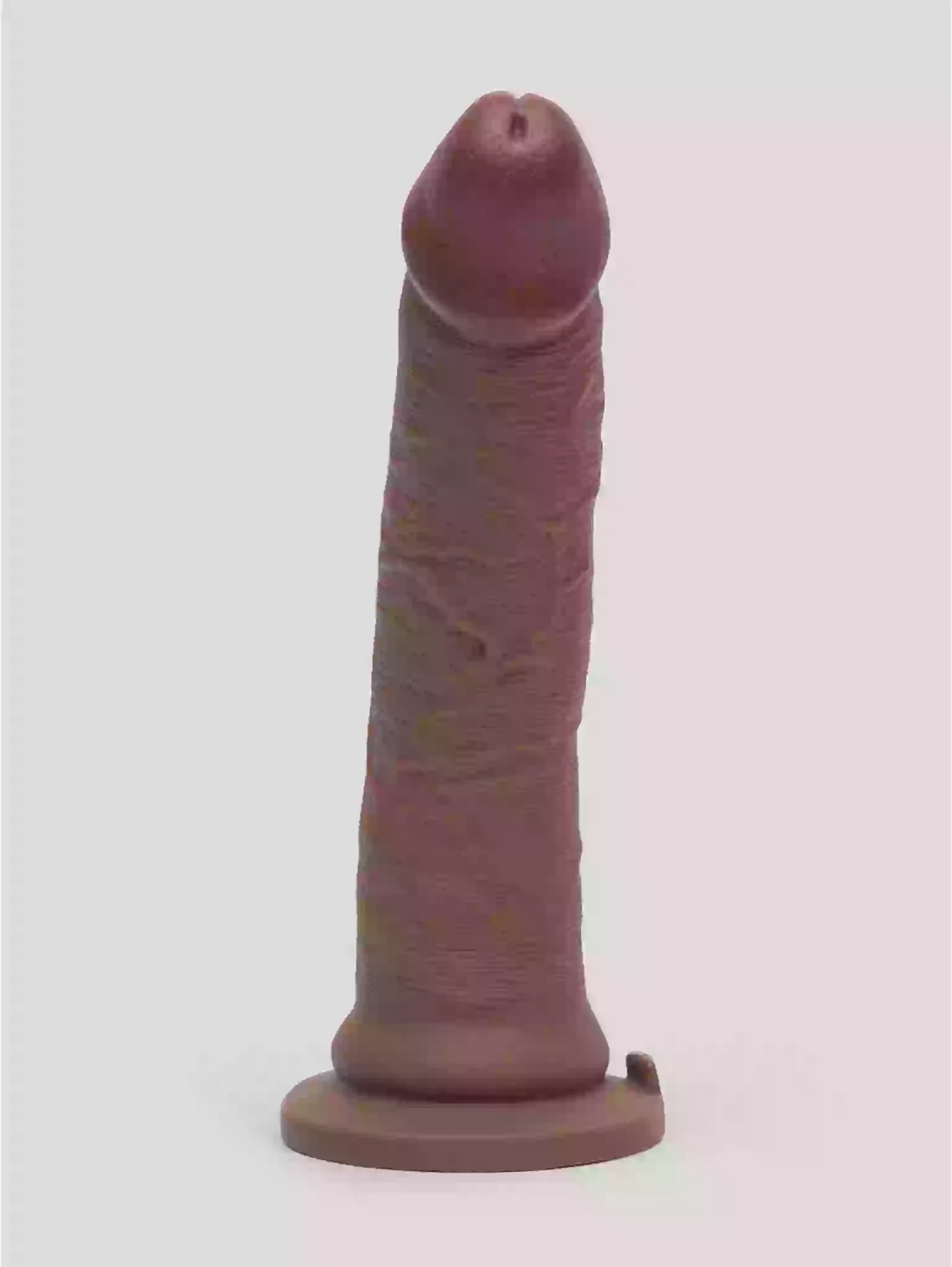 Realistic silicone model of a penis on a white background