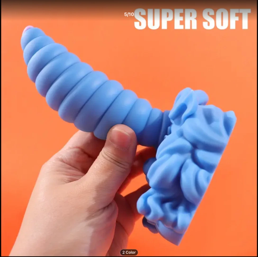 Blue dog toy with wavy texture held by a hand against an orange background, labeled 'SUPER SOFT'.