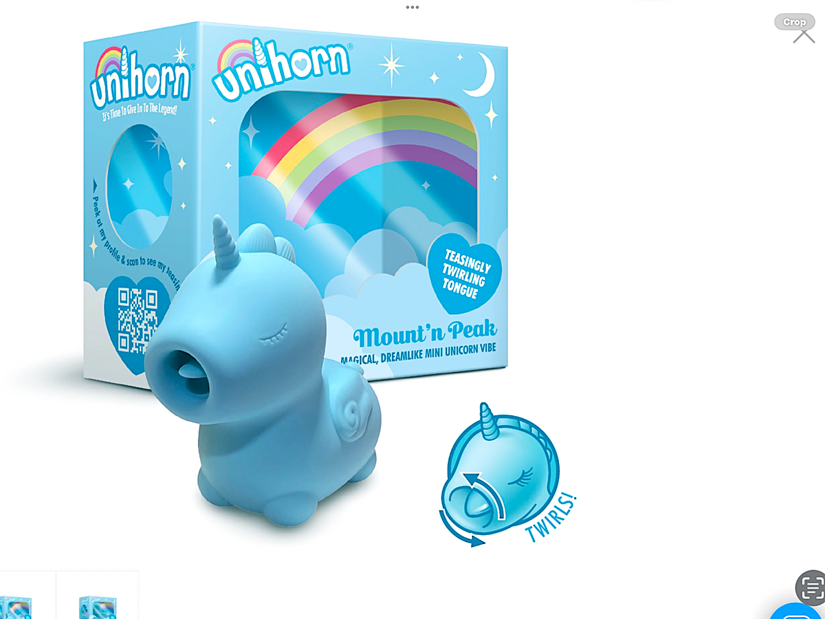 Blue unicorn-shaped toy with packaging featuring a rainbow and stars on a white background