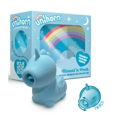 Blue unicorn toy with packaging featuring rainbows and stars on a white background