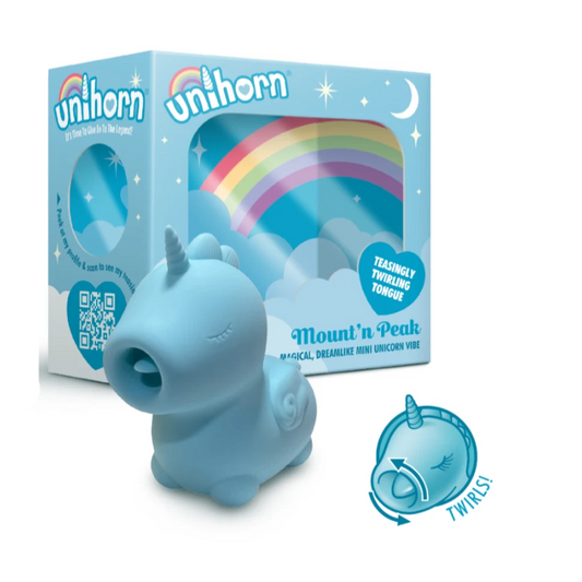 Blue unicorn toy with packaging featuring rainbows and stars on a white background