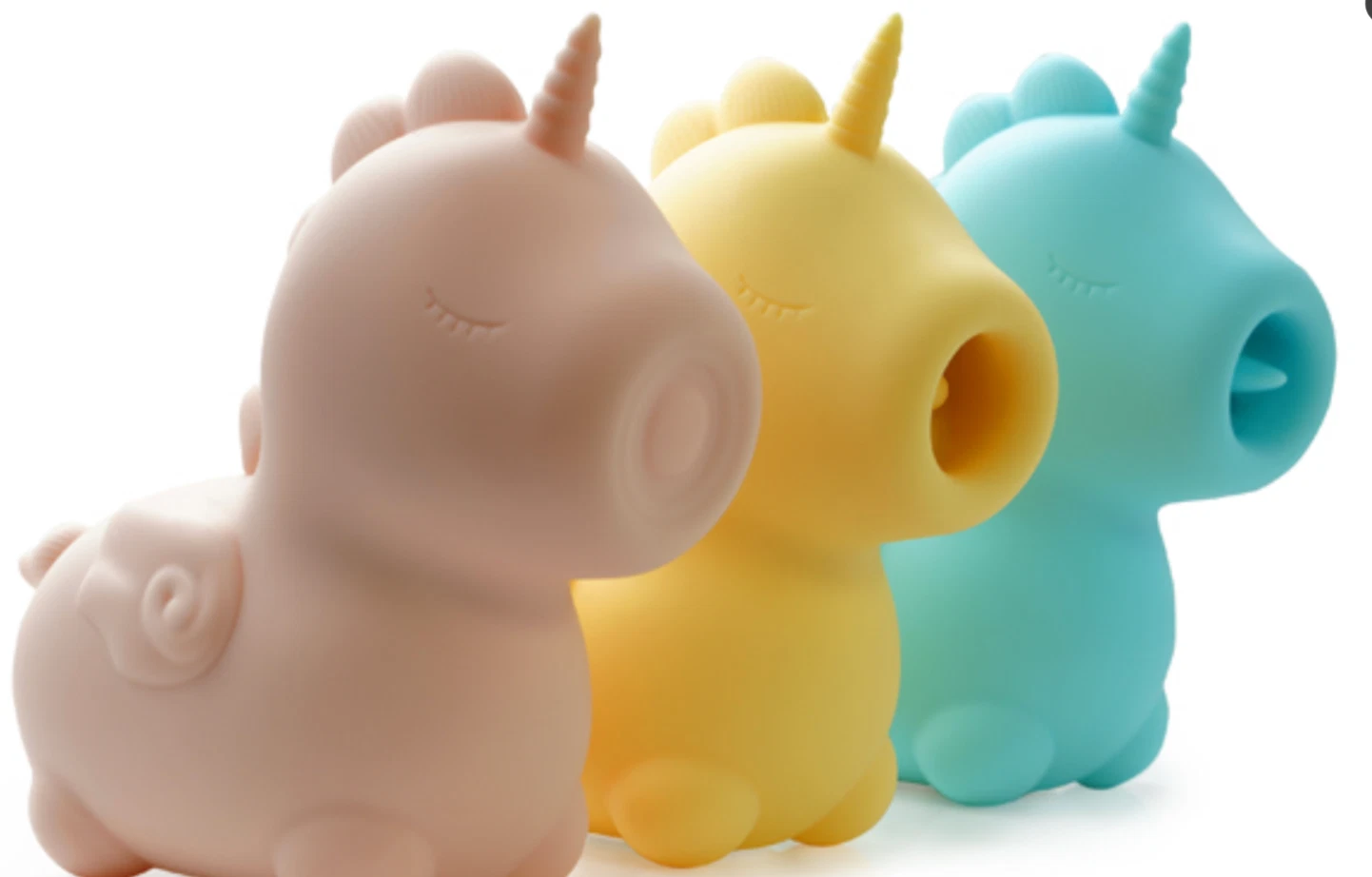 Three colorful unicorn-shaped objects in pink, yellow, and blue on a white background