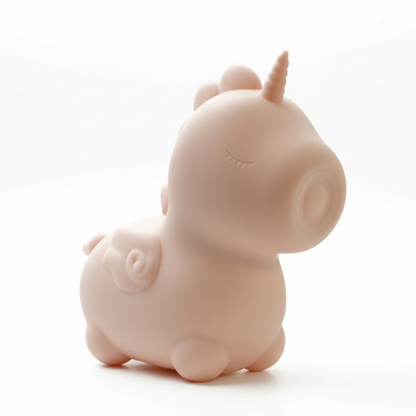 Pink unicorn-shaped object on a white background
