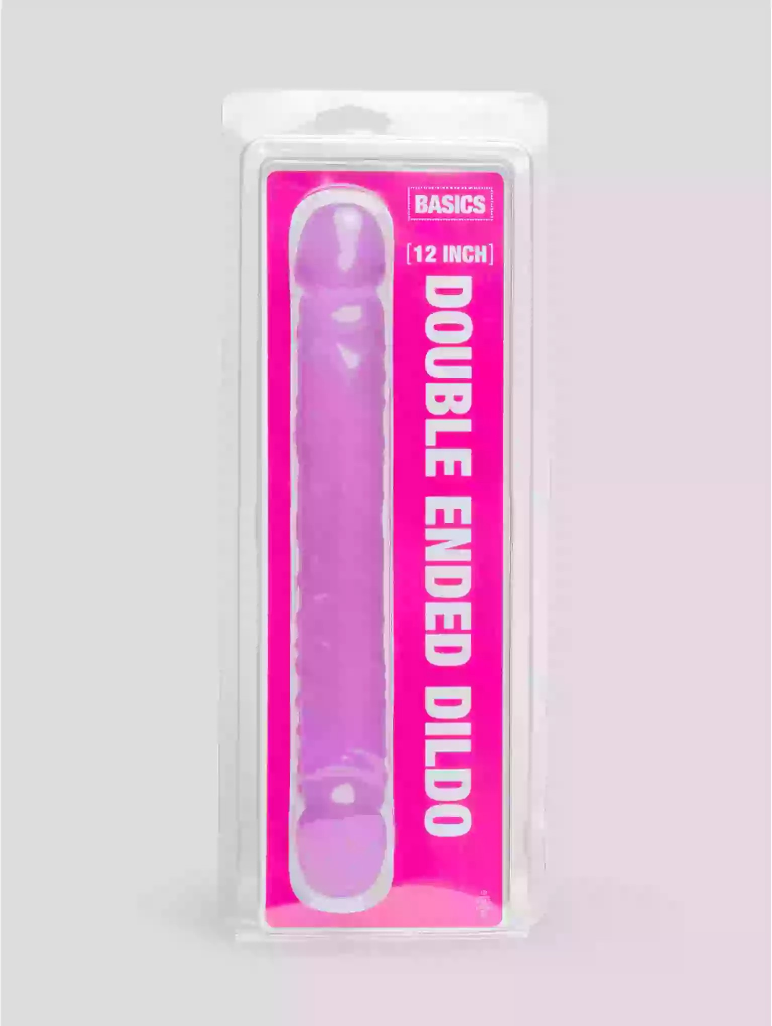 Pink double-ended dildo in packaging with 'Basics' branding on a gray background